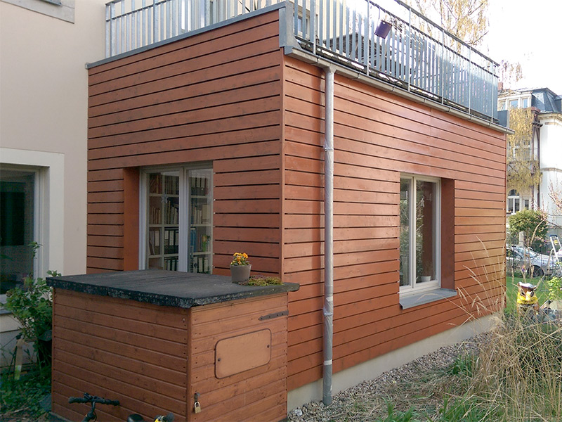 Haus mit neuer Holzverkleidung und Balkon